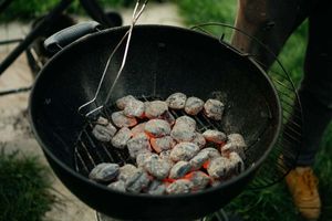 What are the advantages of lighting a barbecue with charcoal instead of firewood?